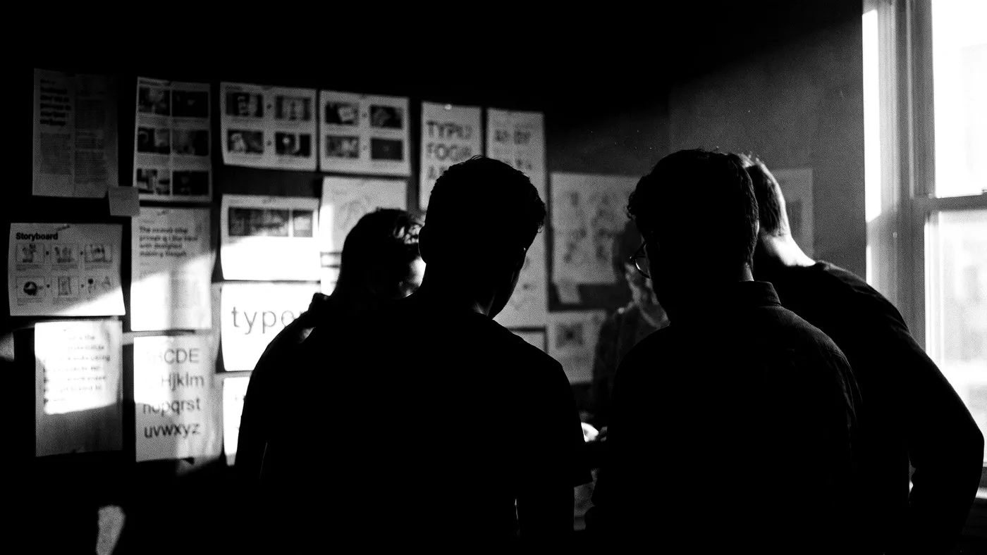 Campaign work reviewed across a studio wall